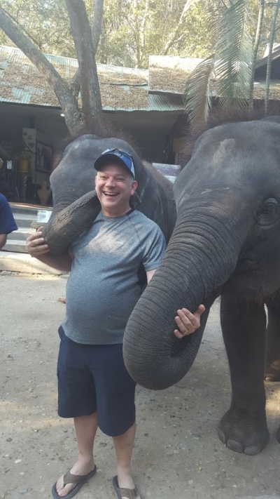 Dean with baby elephant in Shiang Mai